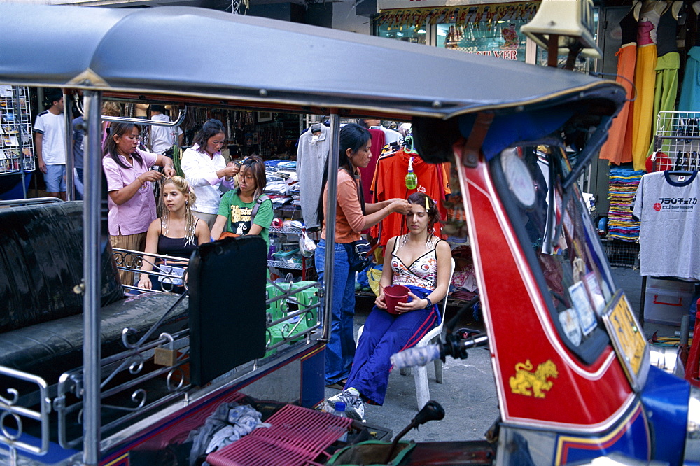 Tourists having their hair braided on Khao San Road, Bangkok, Thailand, Southeast Asia, Asia