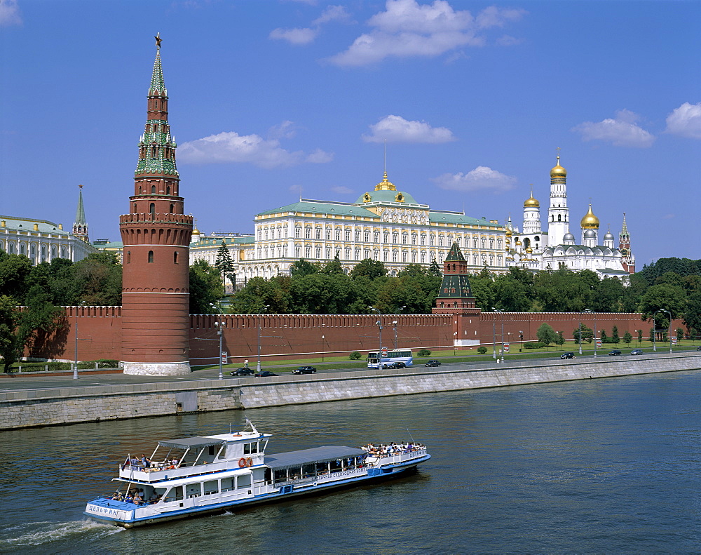 The Kremlin, UNESCO World Heritage Site, and Moskva River with tourist boat, Moscow, Russia, Europe