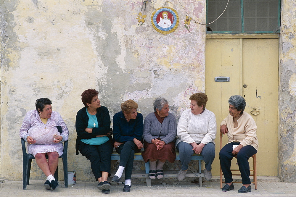 Group of elderly local women chatting, Marsaxlokk, Malta, Europe