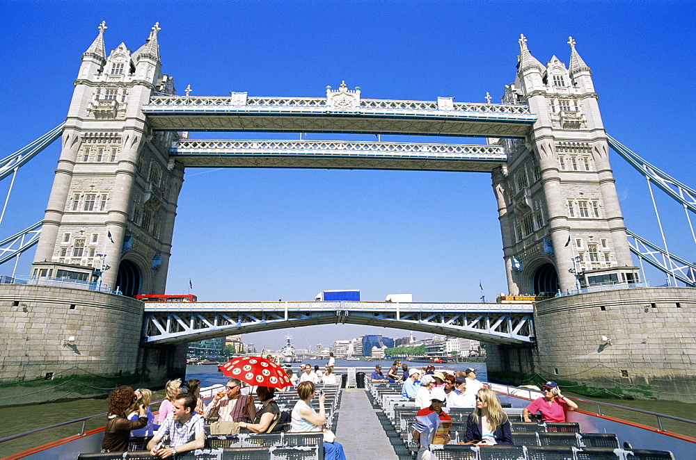 Tourists on tour boat passing under Tower Bridge, London, England, United Kingdom, Europe