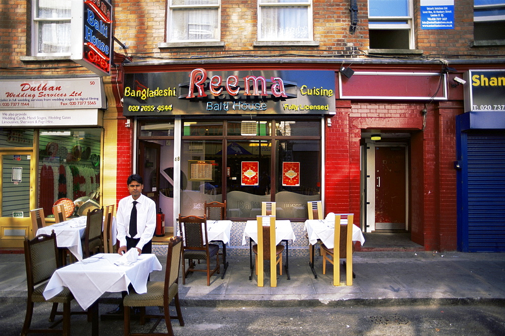 Waiter setting tables in Brick Lane, East End, London, England, United Kingdom, Europe