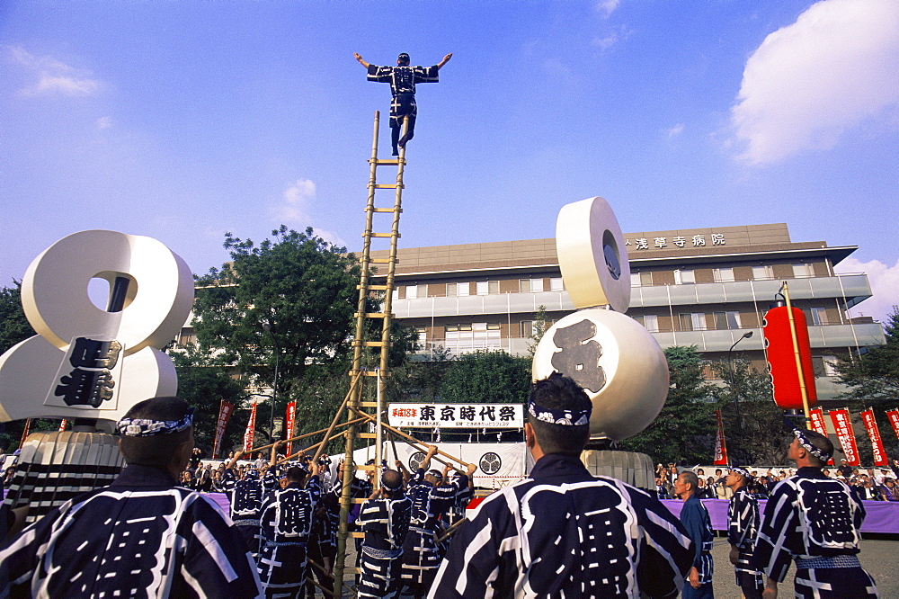 Acrobatic display by firemen at Jidai Matsuri Festival held annually in November at Sensoji Temple, Asakusa, Tokyo, Japan, Asia