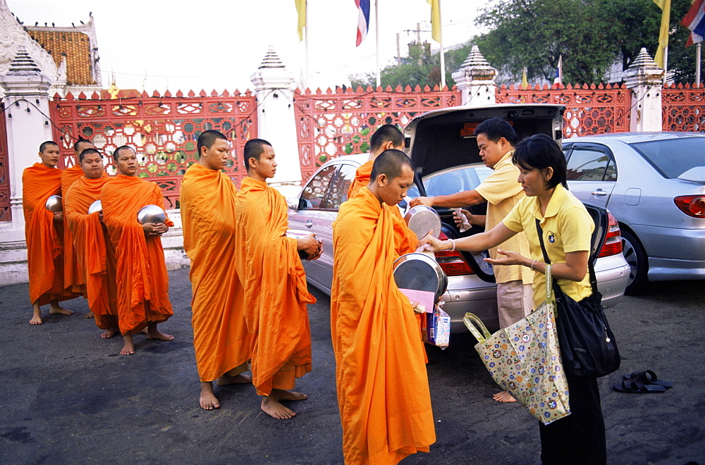 Monks accepting offerings of food at the Marble Temple (Wat Benchamabophit), Bangkok, Thailand, Southeast Asia, Asia