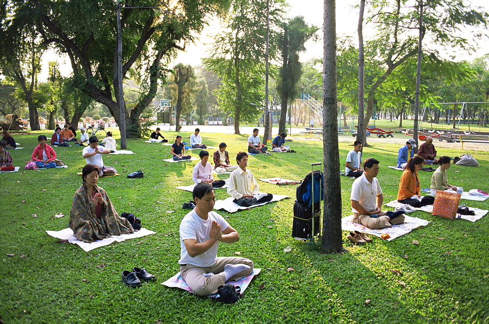 People meditating in Lumphini Park, Bangkok, Thailand, Southeast Asia, Asia