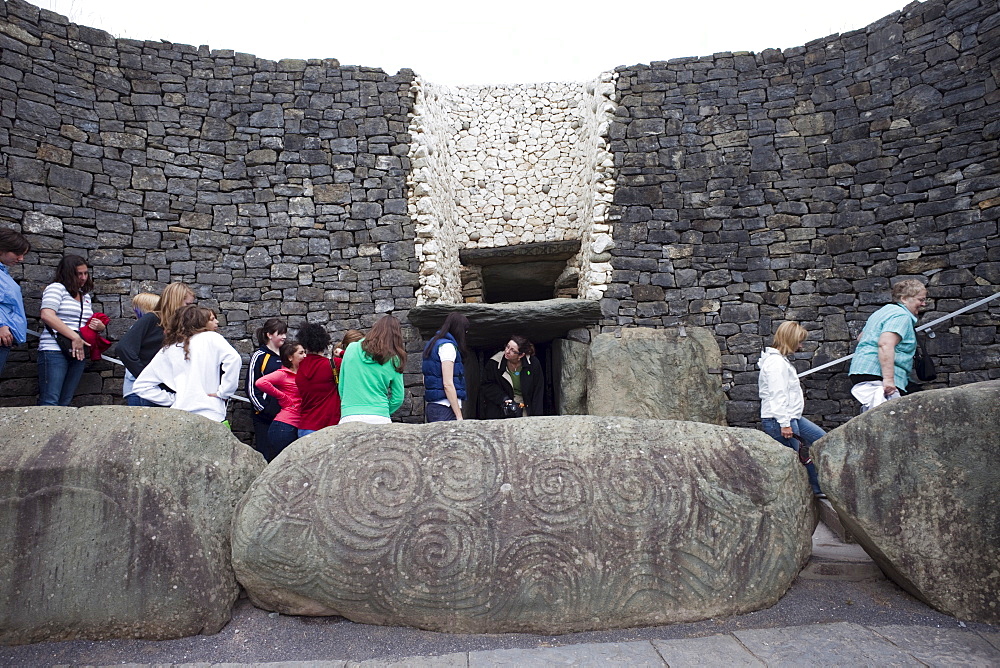 Tourists entering Newgrange Megalithic Tomb, UNESCO World Heritage Site, County Meath, Leinster, Republic of Ireland, Europe