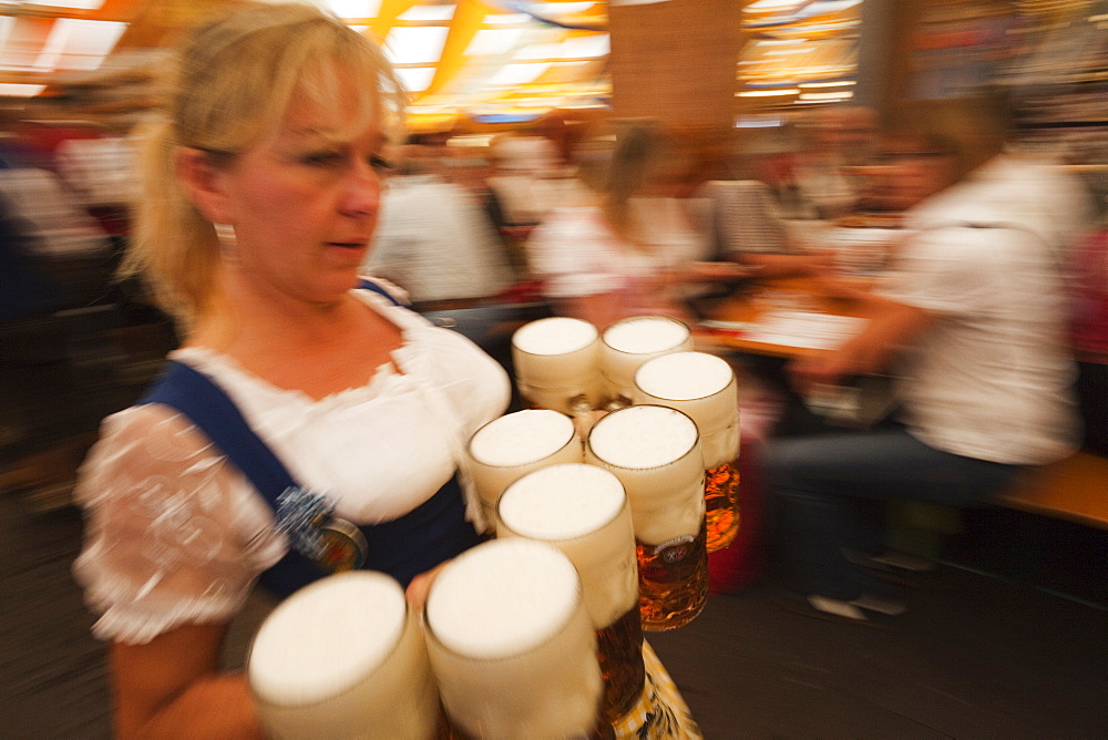 Waitress with beer steins, Oktoberfest, Munich, Bavaria, Germany, Europe