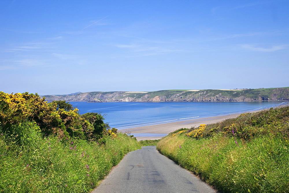 Empty road and beach, Pembrokeshire Coast National Park, Pembrokeshire, Wales, United Kingdom, Europe