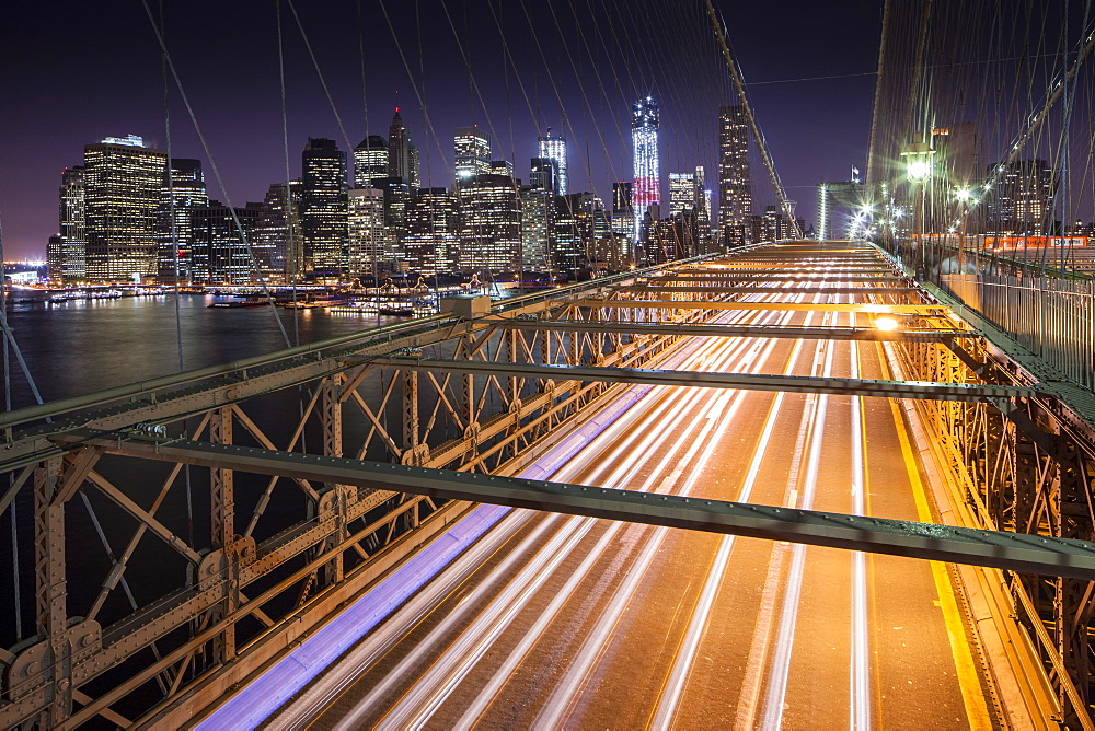 Traffic leaves colourful trails along the Brooklyn Bridge in New York, New York State, United States of America, North  America