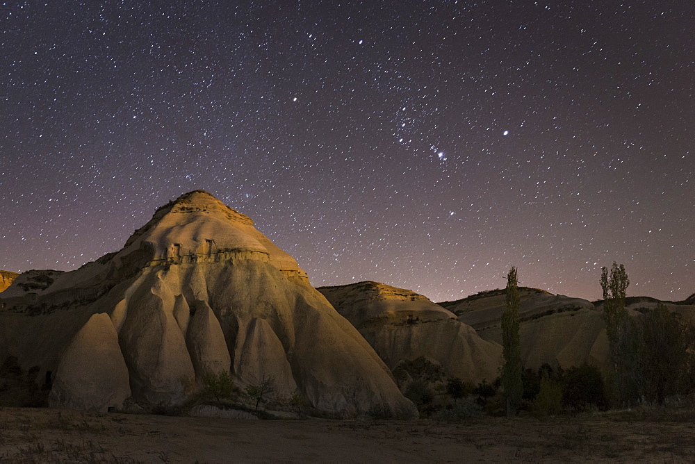 Night time in the Rose Valley showing the rock formations and desert landscape light painted with torches, Cappadocia, Anatolia, Turkey, Asia Minor, Eurasia