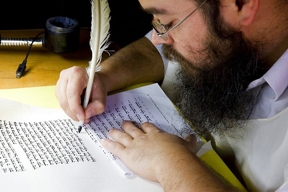 Photograph of an Orthodox Jew doing the work of copyist of the scriptures, Israel