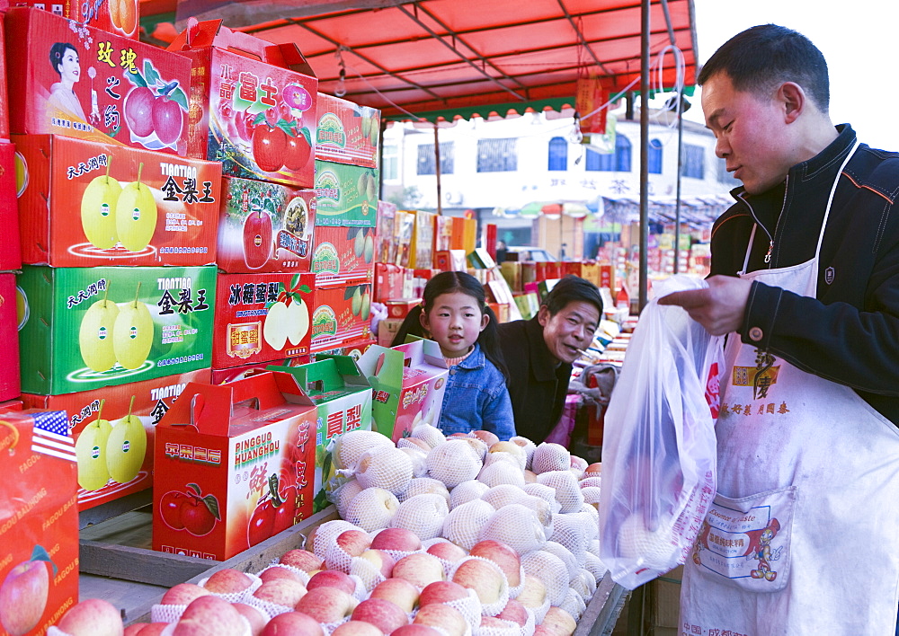 A Chinese small family business selling fruit in colorful gift boxes during the Chinese New Year holiday, Chengdu, Sichuan, China, Asia