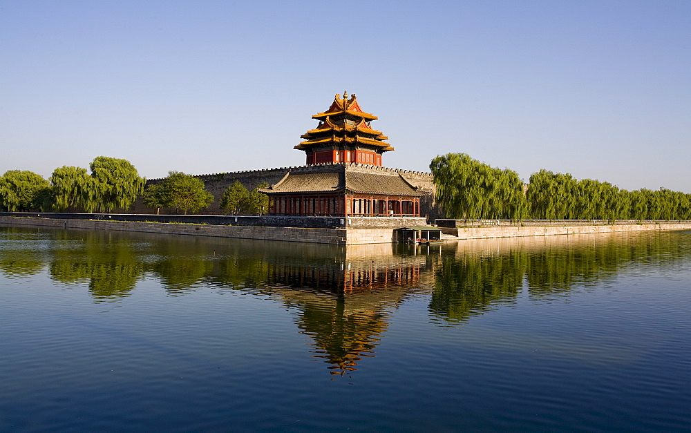 The northwest corner tower and water filled moat surrounding The Forbidden City, Beijing, China, Asia