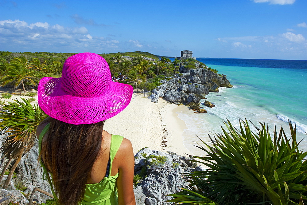 Tourist on the Caribbean coast looking over Tulum Beach to the ancient Mayan site of Tulum, Tulum, Quintana Roo, Mexico, North America