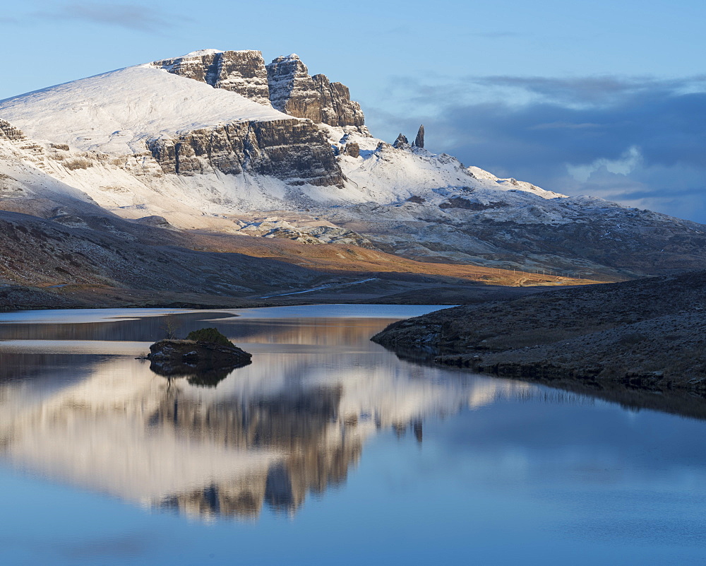 The Storr reflected in the calm waters of Loch Fada on a winter morning, Isle of Skye, Inner Hebrides, Scotland, United Kingdom, Europe