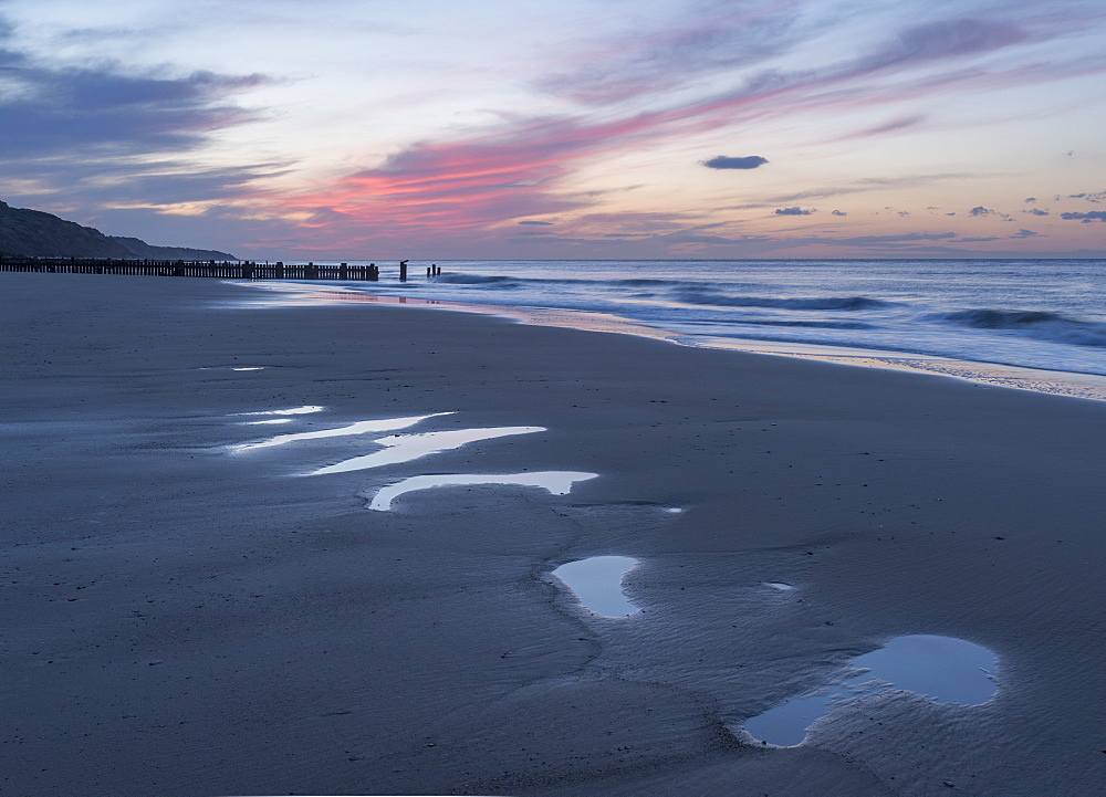 Beautiful sunset colours over the beach at low tide at Mundesley, Norfolk, England, United Kingdom, Europe