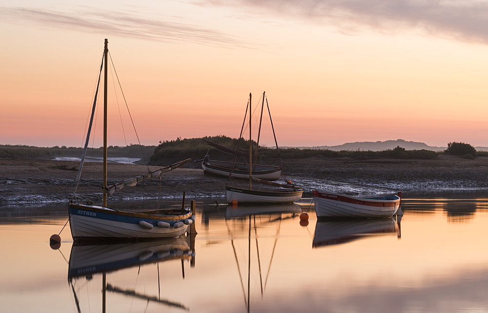 Boats in the channel on a beautiful morning at Burnham Overy Staithe, Norfolk, England, United Kingdom, Europe