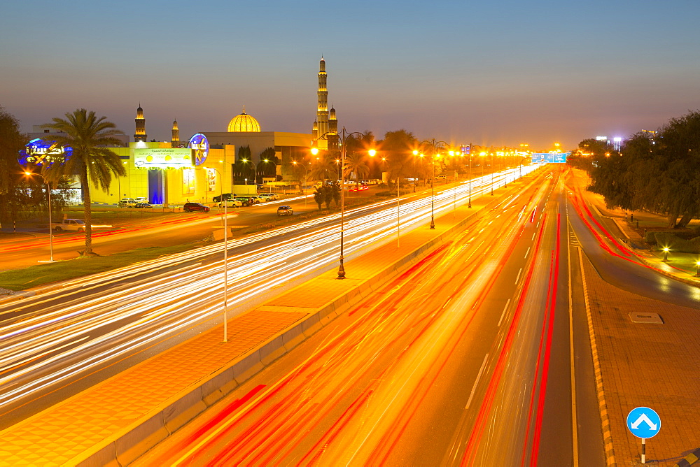 Sultan Qaboos Grand Mosque and traffic on Sultan Qaboos Street at sunset, Muscat, Oman, Middle East