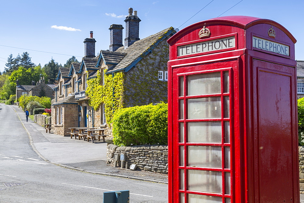 Red telephone box in Beeley Village in springtime, Derbyshire Dales, Derbyshire, England, United Kingdom, Europe