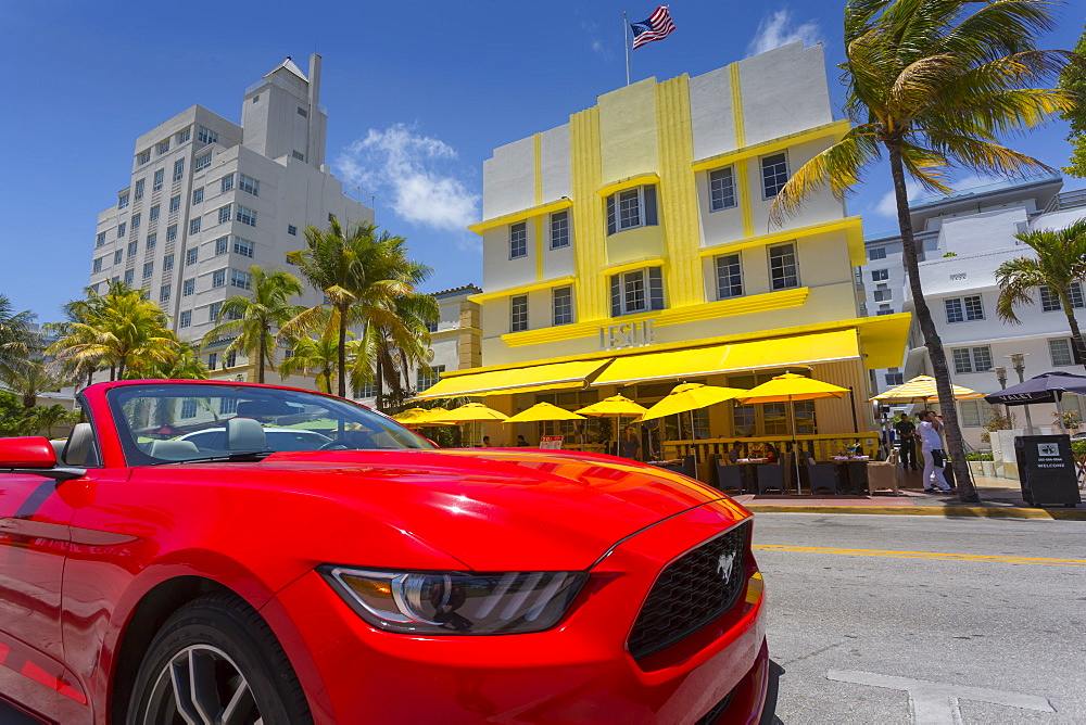 Art Deco architecture and red sports car on Ocean Drive, South Beach, Miami Beach, Miami, Florida, United States of America, North America