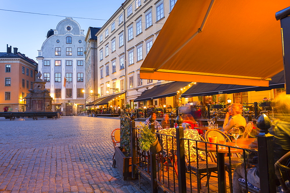 Restaurant and colourful buildings on Stortorget, Old Town Square in Gamla Stan at dusk, Stockholm, Sweden, Scandinavia, Europe