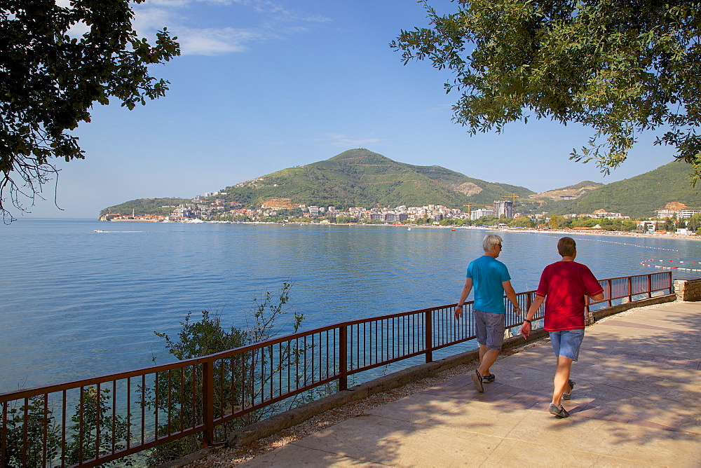 Walkers and Old Town, Budva Bay, Montenegro, Europe