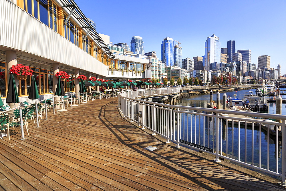 Seattle skyline and restaurants on sunny day in Bell Harbor Marina, Seattle, Washington State, United States of America, North America