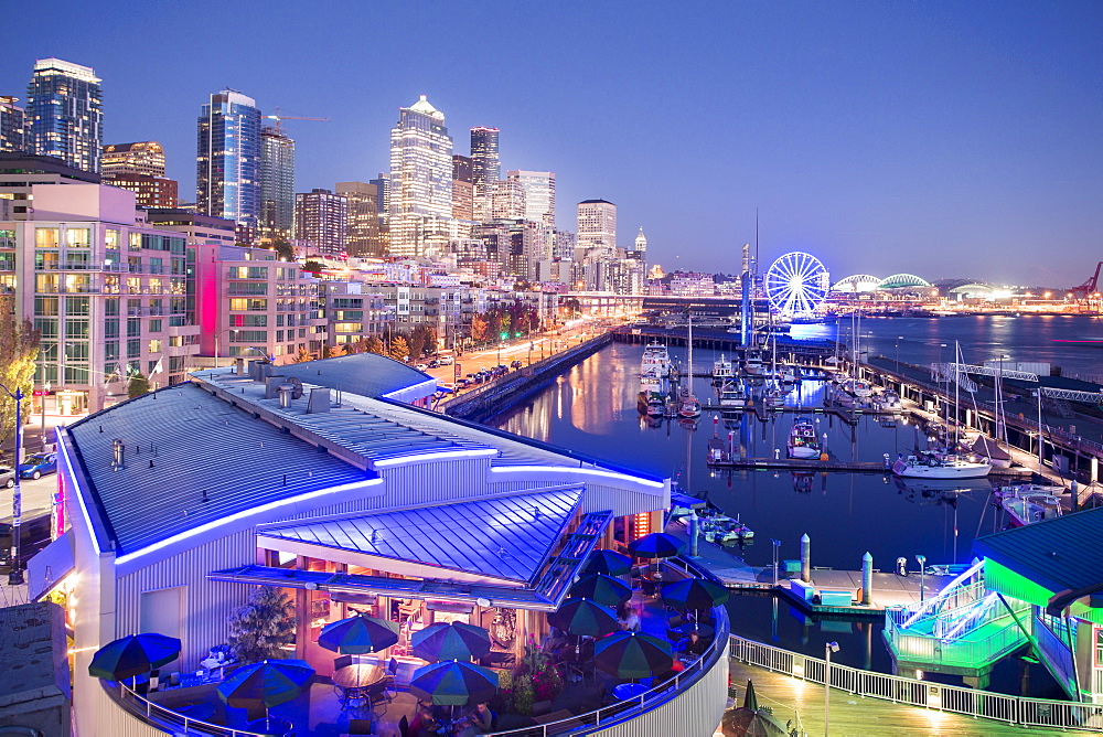 Elevated view of Seattle skyline and restaurants in Bell Harbour Marina at dusk, Belltown District, Seattle, Washington State, United States of America, North America