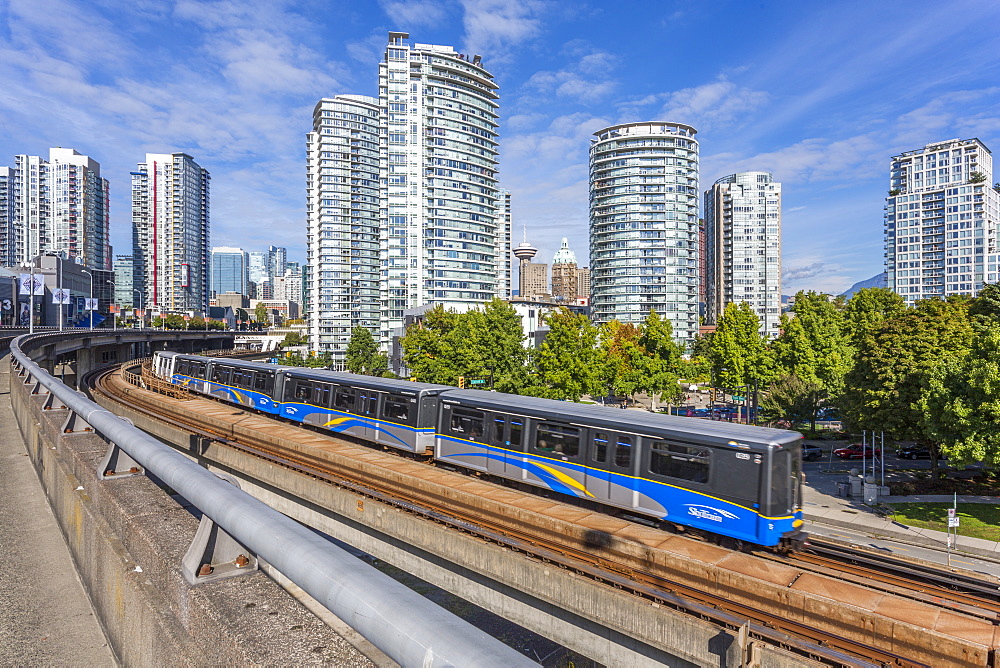 View of Metro Train and urban office blocks and apartments, Vancouver, British Columbia, Canada, North America