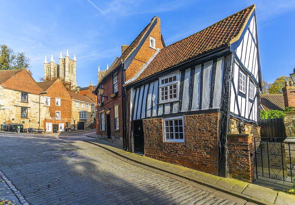 Lincoln Cathedral and timbered architecture viewed from the cobbled Steep Hill, Lincoln, Lincolnshire, England, United Kingdom, Europe