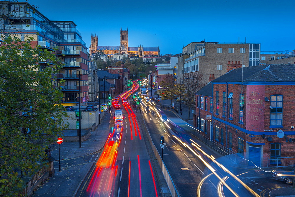 View of Lincoln Cathedral and traffic on Broadgate at dusk, Lincoln, Lincolnshire, England, United Kingdom, Europe