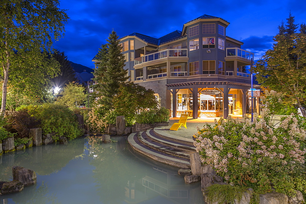 Illuminated shops on Village Stroll at dusk, Whistler, British Columbia, Canada, North America