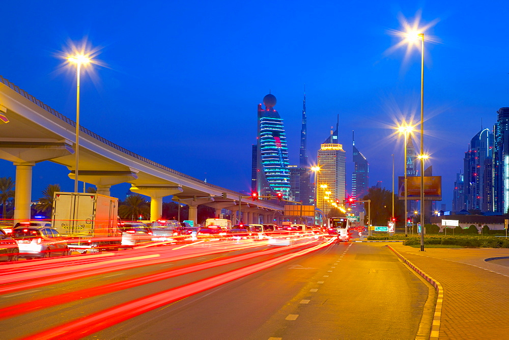 City skyline and car trail lights at sunset, Dubai, United Arab Emirates, Middle East