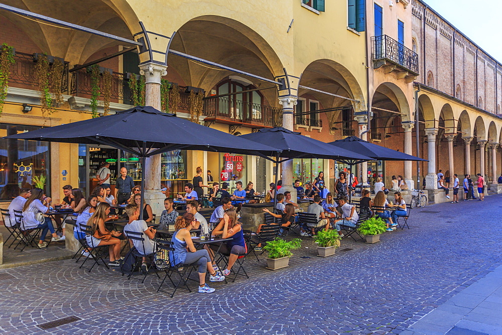 View of pastel coloured architecture, pedestrians and cafe on cobbled street of Via Roma, Padua, Veneto, Italy, Europe