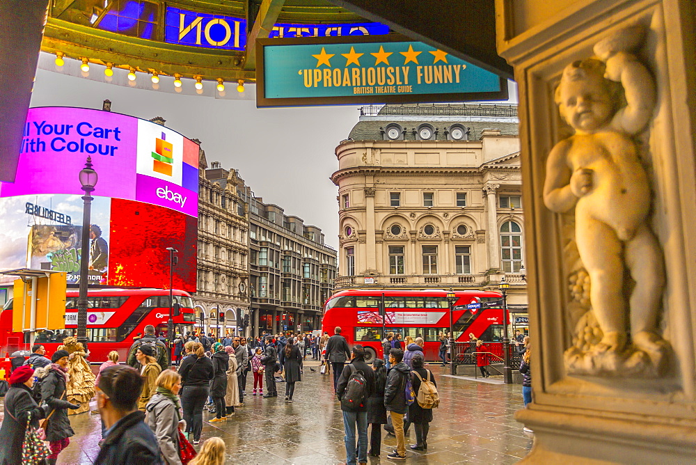 Red buses travelling through Piccadilly Circus from the Criterion Theatre, London, England, United Kingdom, Europe