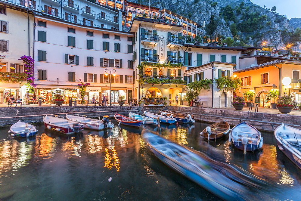 View of illuminated promenade at the port of Limone at dusk, Lake Garda, Lombardy, Italian Lakes, Italy, Europe