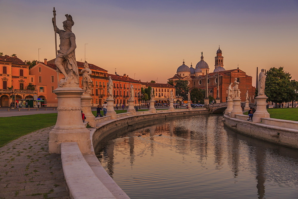 View of statues in Prato della Valle at dusk and Santa Giustina Basilica visible in background, Padua, Veneto, Italy, Europe