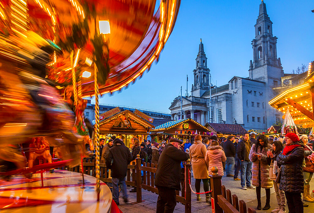 View of carousel and Christmas Market stalls at Christmas Market, Millennium Square, Leeds, Yorkshire, England, United Kingdom, Europe