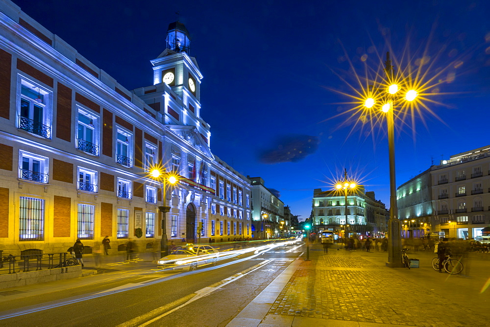 Trail lights and Real Casa de Correos at Puerta del Sol at dusk, Madrid, Spain, Europe