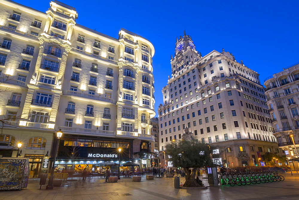 View of architecture illuminated on Gran Via at dusk, Madrid, Spain, Europe