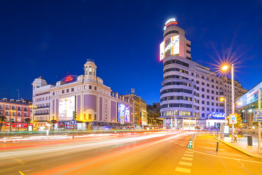 View of architecture and trail lights on Gran Via and Plaza del Calao at dusk, Madrid, Spain, Europe