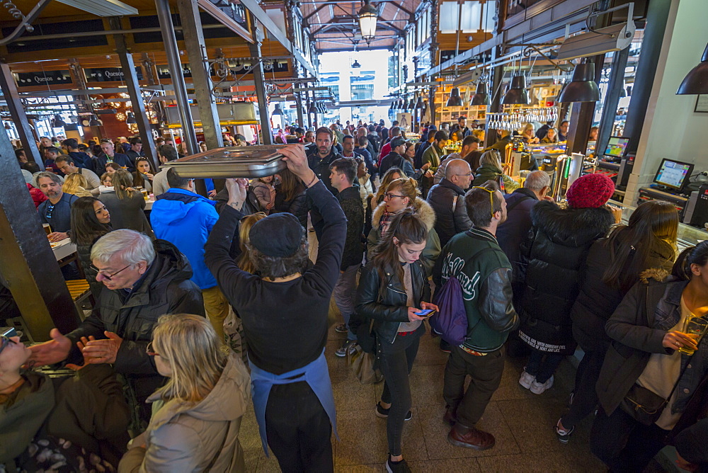 Hustle and bustle of the interior of San Miguel Market, Madrid, Spain, Europe