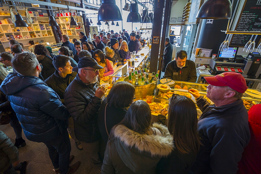 Hustle and bustle of the interior of San Miguel Market, Madrid, Spain, Europe