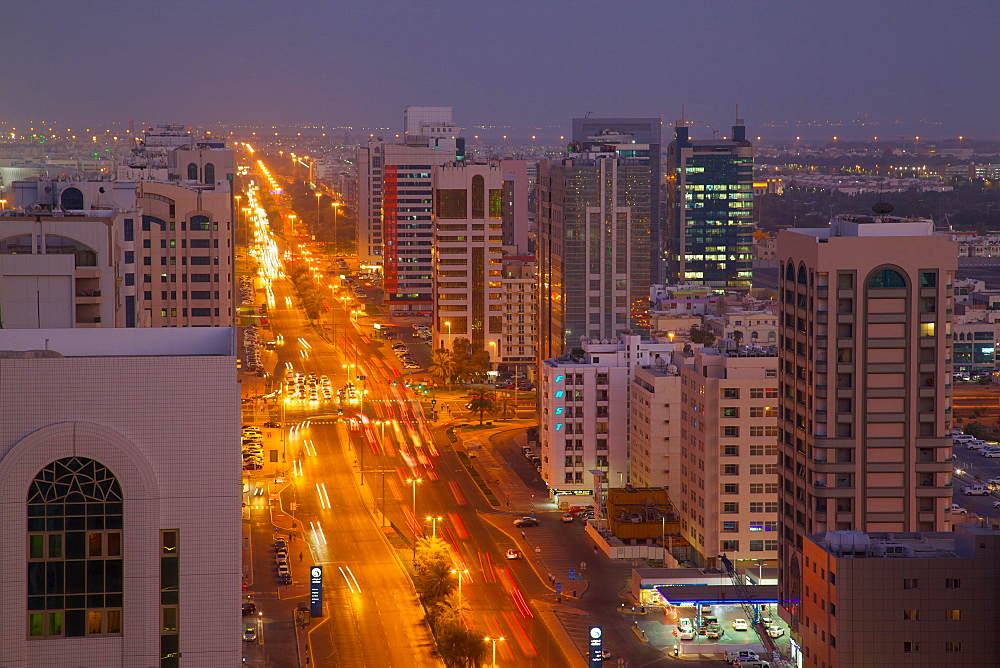 City skyline and Rashid Bin Saeed Al Maktoum Street at dusk, Abu Dhabi, United Arab Emirates, Middle East 