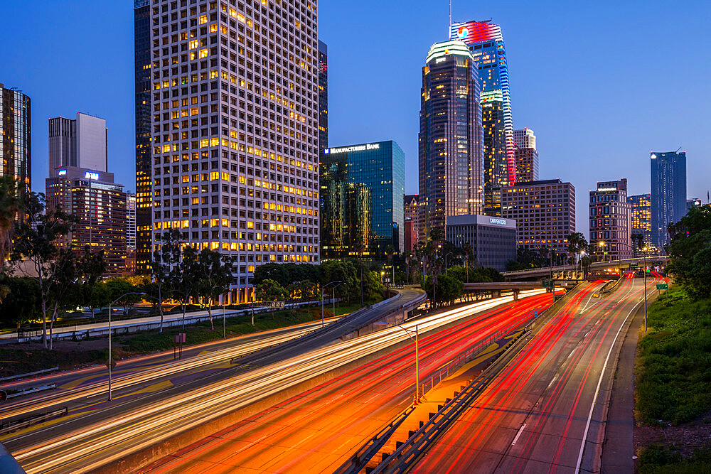 View of Downtown skyline and Harbour Freeway at dusk, Los Angeles, California, United States of America, North America