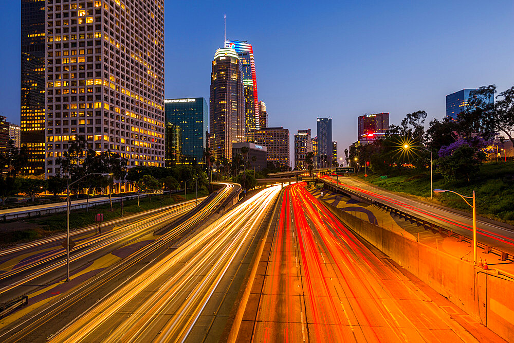 View of Downtown skyline and Harbour Freeway at dusk, Los Angeles, California, United States of America, North America