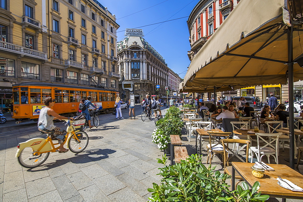 View of restaurant, tram and pedestrians on Via Dante, Milan, Lombardy, Italy, Europe