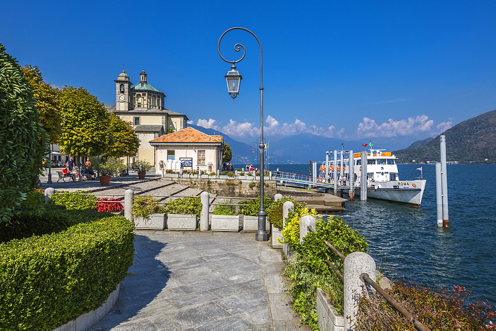 Cruiseboat moored near harbour and Santuario della SS Pieta Church in Cannobio, Lake Maggiore, Piedmont, Italian Lakes, Italy, Europe