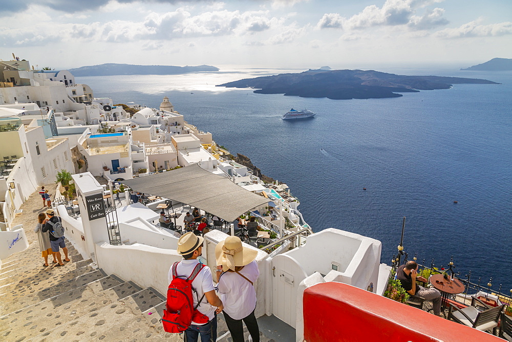 View of Fira restaurants and cruise ship, Firostefani, Santorini (Thira), Cyclades Islands, Greek Islands, Greece, Europe