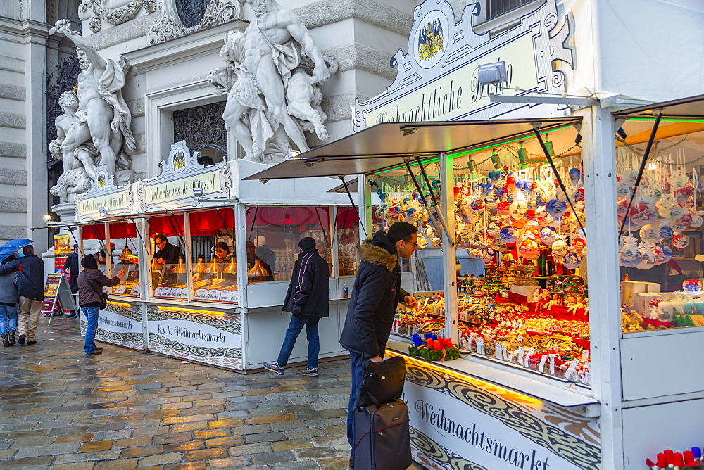 Shoppers at Christmas market stalls in Michaelerplatz, Vienna, Austria, Europe