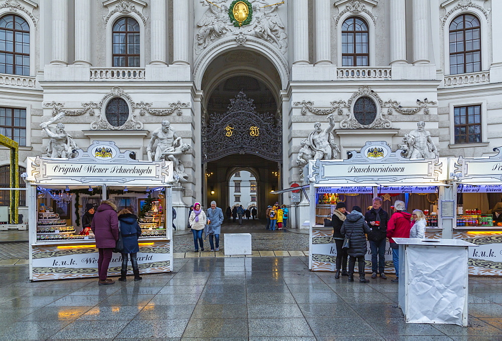 Shoppers at Christmas market stalls in Michaelerplatz, Vienna, Austria, Europe